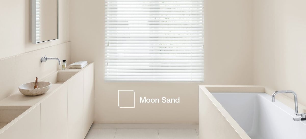 Modern bathroom with vanity sink, bathtub, and window blinds; text: Moon Sand.