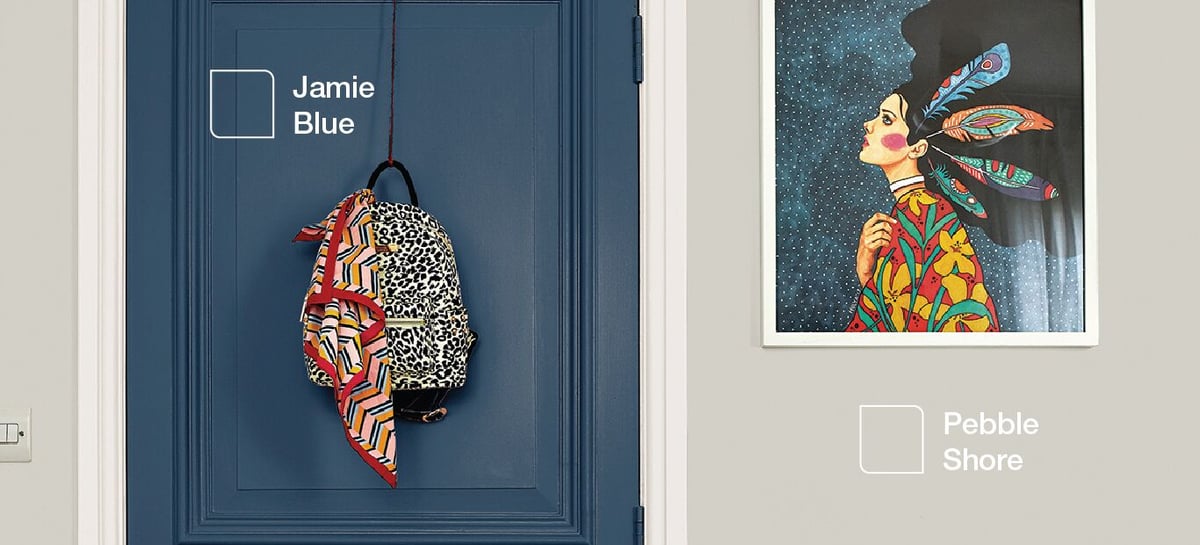 Blue front door with a leopard-print decorative wreath, plus framed butterfly artwork and “Pebble Shore” label.