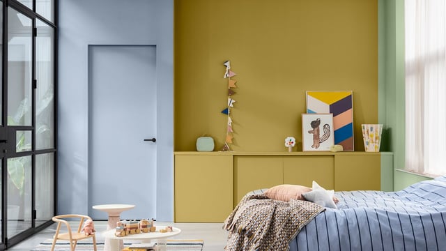 Bright bedroom with a double bed, yellow feature wall, decor shelf, and large window.
