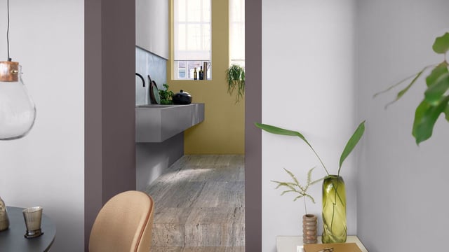 Bright kitchen nook with a niche, green vase with a plant, and modern décor