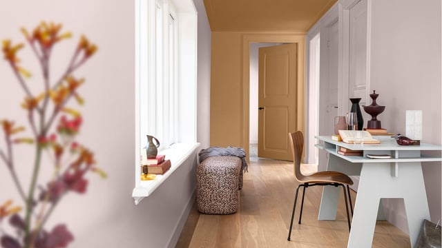 Warm home office: desk by the window, chair and decor in a calm room with a table lamp